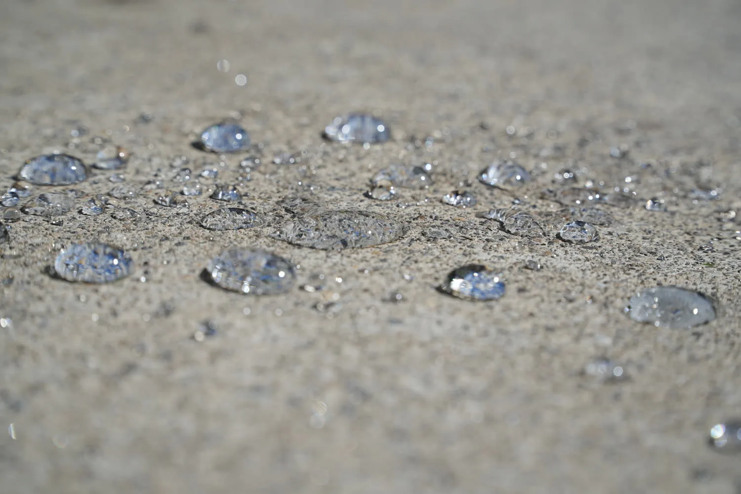 Water beading on a NexaNano-treated concrete driveway