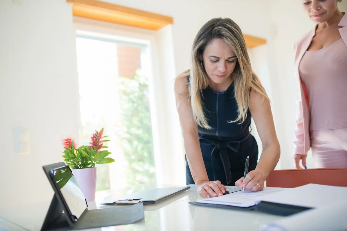 Property manager reviewing paperwork outside a managed rental home